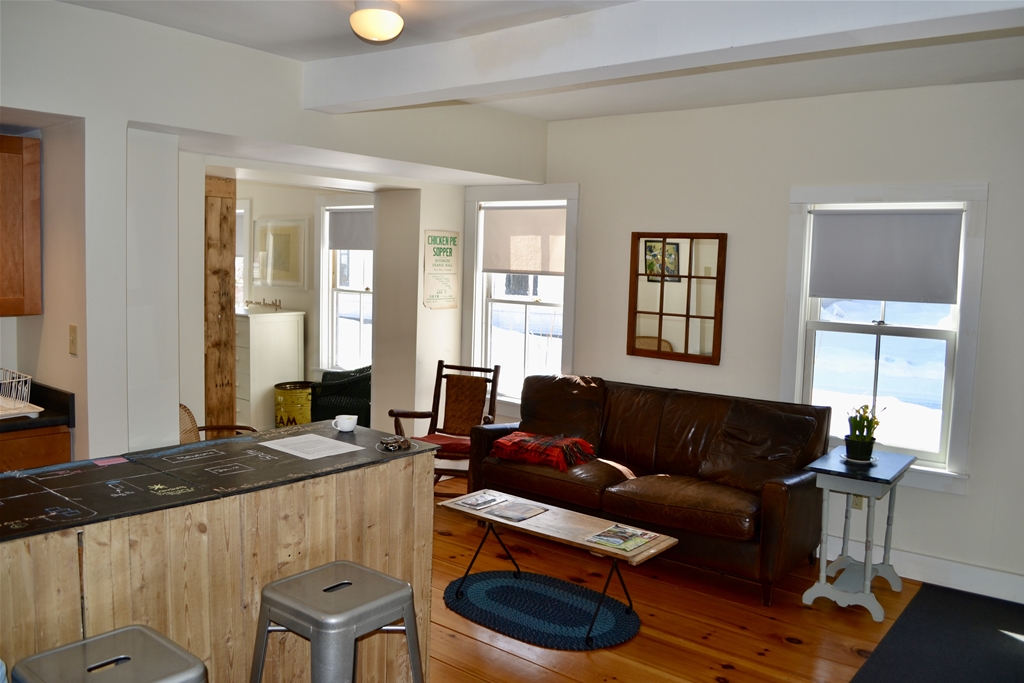 Couch, chair and entrance to first floor bedroom